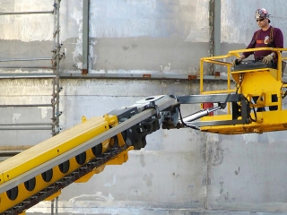 headshot of man on lift at a power plant