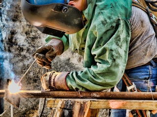 headshot of a welder working
