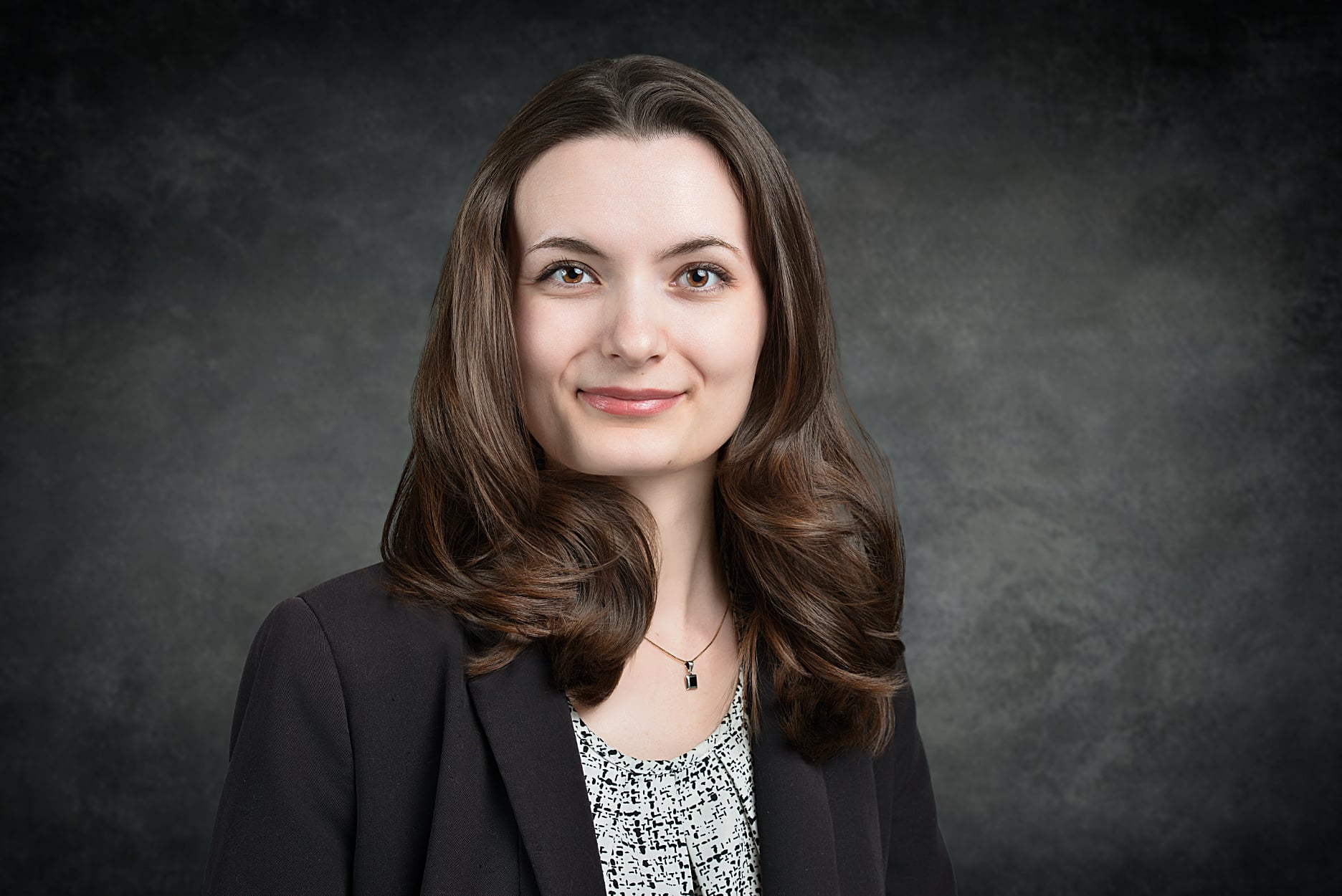 Phoenix corporate headshot professional headshot image of young lady with brown hair and a grey backdrop